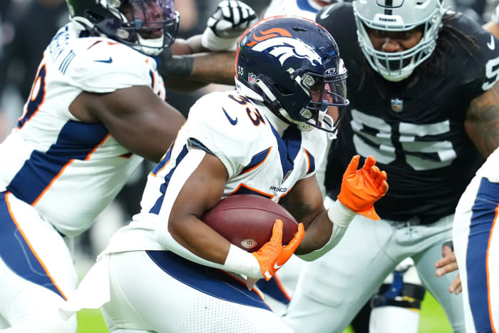 Denver Broncos running back Javonte Williams (33) carries against the Las Vegas Raiders during the first quarter at Allegiant Stadium.